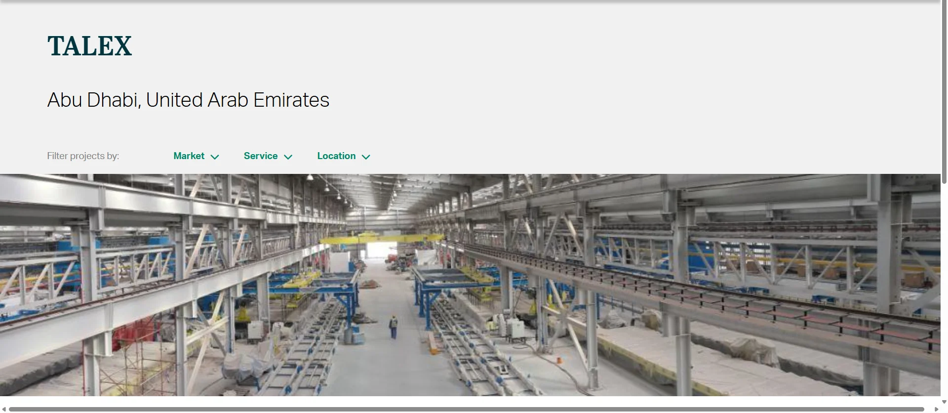 Interior view of the massive TALEX aluminum extrusion plant in Abu Dhabi, United Arab Emirates, showcasing heavy industrial equipment and automated production lines.