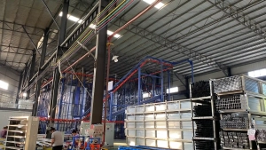 Wide view of our advanced automated powder coating line and large-scale storage racks for extruded aluminum profiles.